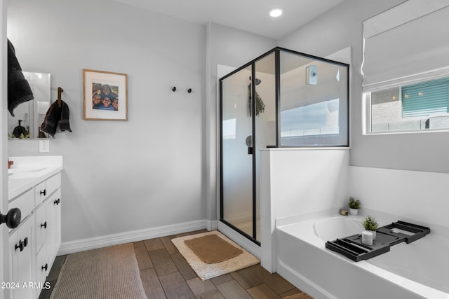5871 N 187th Ln, Litchfield Park, AZ 85340 - bathroom with a shower stall, vanity, a bath, and wood finished floors