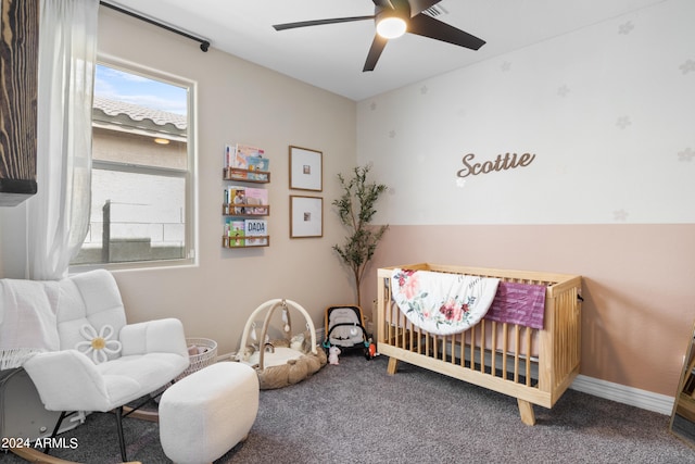 5871 N 187th Ln, Litchfield Park, AZ 85340 - carpeted bedroom with a crib, ceiling fan, and baseboards