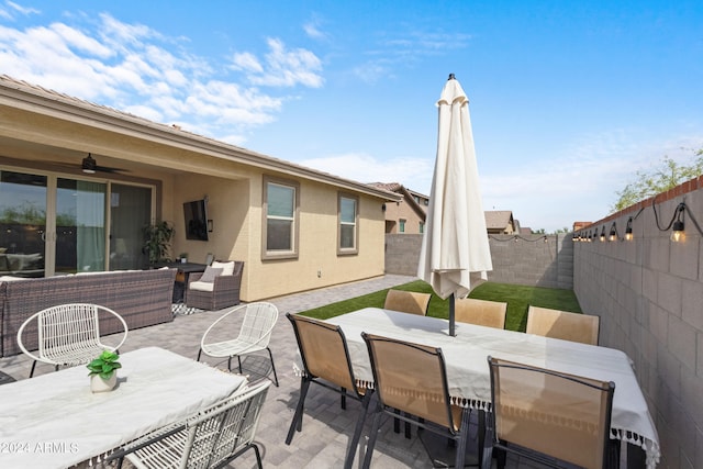 5871 N 187th Ln, Litchfield Park, AZ 85340 - fenced backyard featuring outdoor dining area, a patio, a ceiling fan, and outdoor lounge area