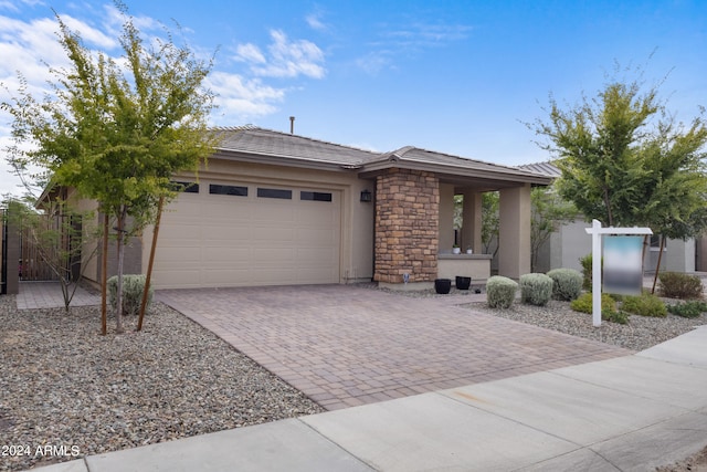 5871 N 187th Ln, Litchfield Park, AZ 85340 - view of front of home with decorative driveway, stucco siding, a garage, stone siding, and a tiled roof