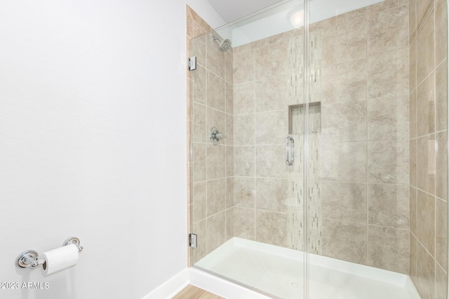 bathroom featuring a shower with shower door