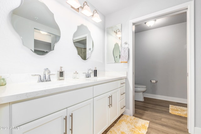 bathroom with vanity, hardwood / wood-style floors, and toilet