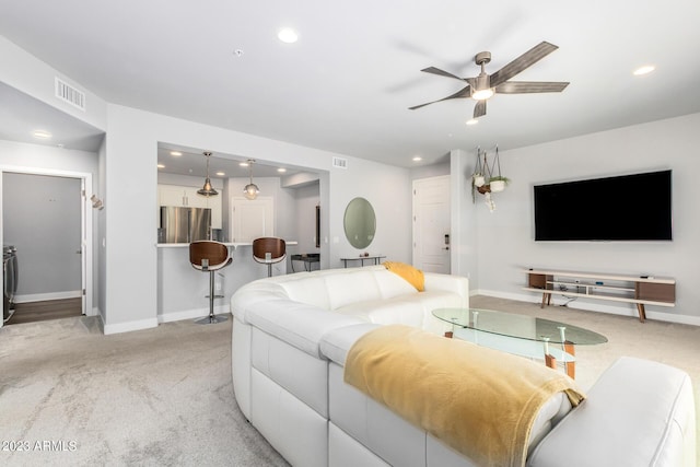 living room featuring light carpet and ceiling fan