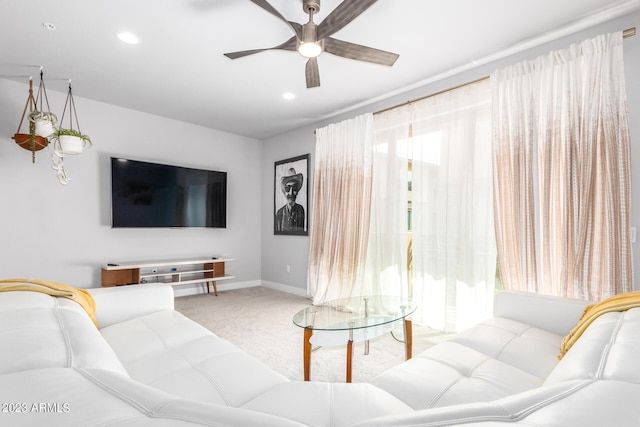 carpeted living room featuring ceiling fan