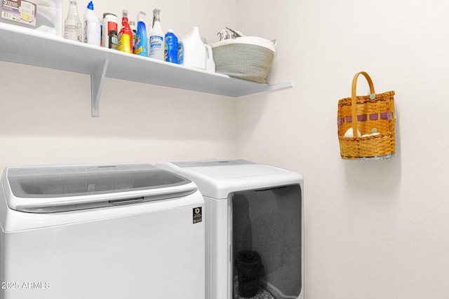 clothes washing area featuring laundry area and washing machine and clothes dryer