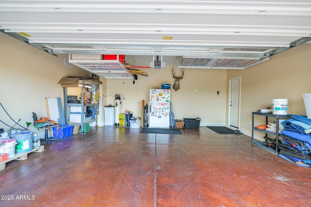 garage with a garage door opener and baseboards