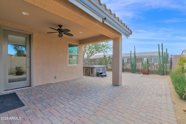 view of patio featuring ceiling fan and fence