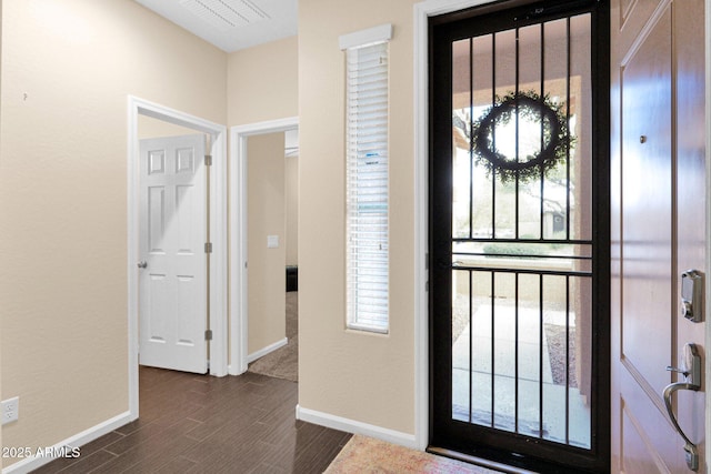 entrance foyer with dark wood finished floors and baseboards