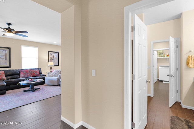 hall with baseboards and wood finished floors