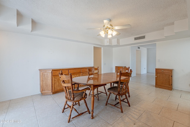 dining space featuring ceiling fan, a textured ceiling, and light tile patterned flooring