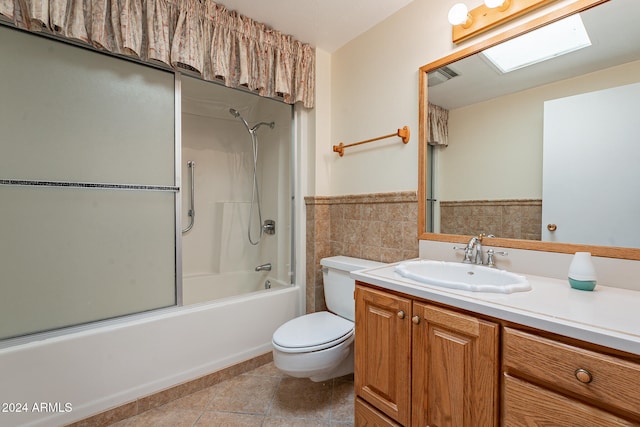 full bathroom featuring  shower combination, toilet, tile walls, vanity, and tile patterned flooring