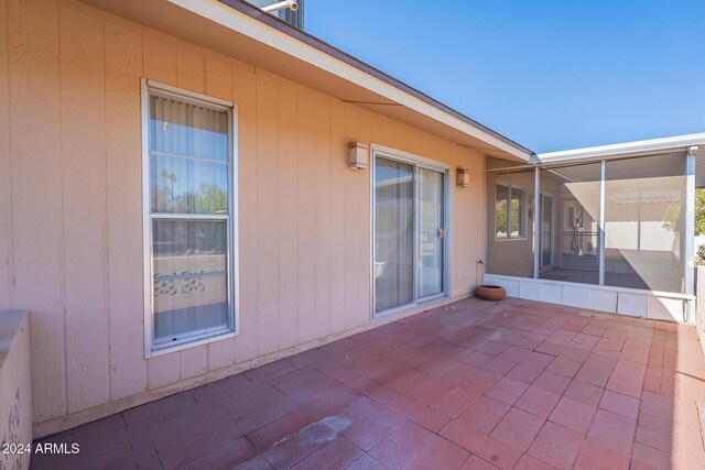 view of patio featuring a sunroom