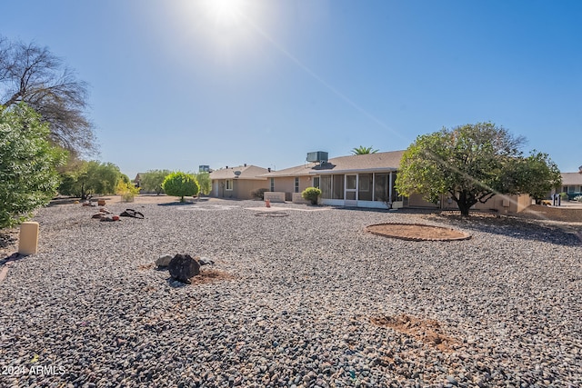 rear view of house featuring a sunroom