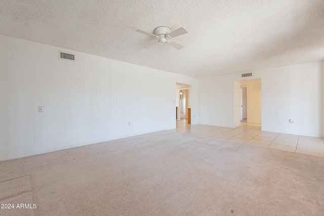 tiled empty room with a textured ceiling and ceiling fan