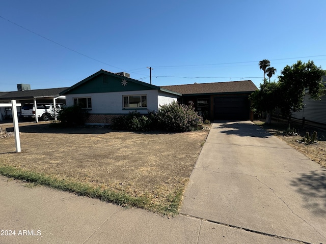 view of front of property featuring a garage and a carport