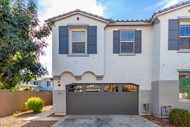 mediterranean / spanish-style home with a garage