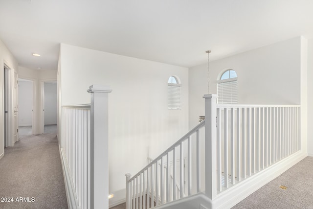 hallway featuring light carpet