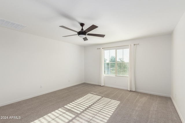 carpeted spare room with ceiling fan