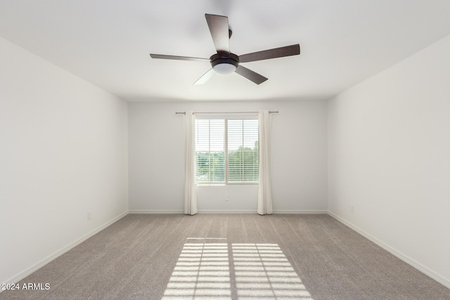 unfurnished room featuring light colored carpet and ceiling fan