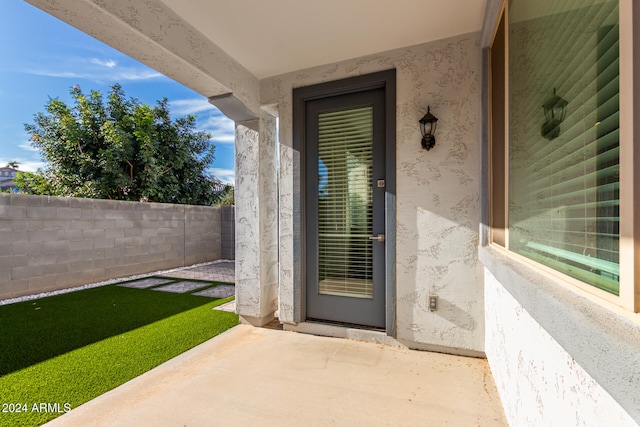 property entrance featuring a patio area