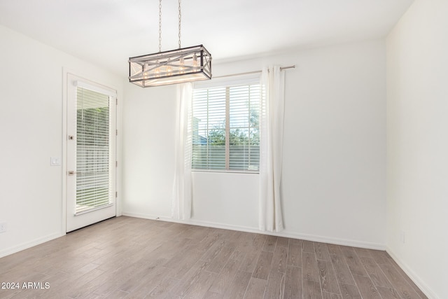 unfurnished dining area featuring light hardwood / wood-style floors and a healthy amount of sunlight