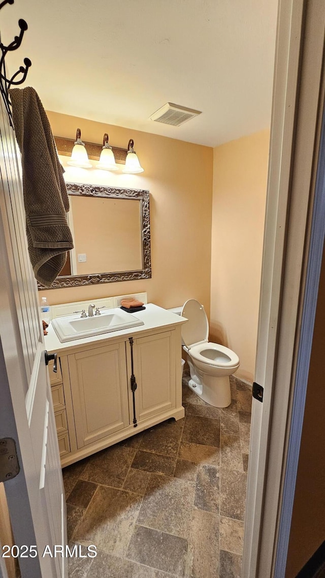 30940 N Varnum Rd, San Tan Valley, AZ 85143 - half bath featuring stone tile flooring, vanity, and toilet