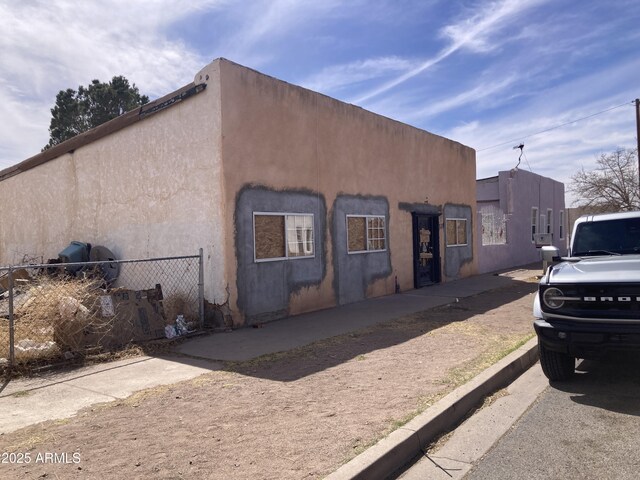 339 E 6th St, Douglas, AZ 85607 - view of home's exterior featuring stucco siding and fence