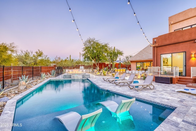 30020 N 63rd St, Cave Creek, AZ 85331 - pool at dusk featuring a patio, a pool with connected hot tub, and a fenced backyard
