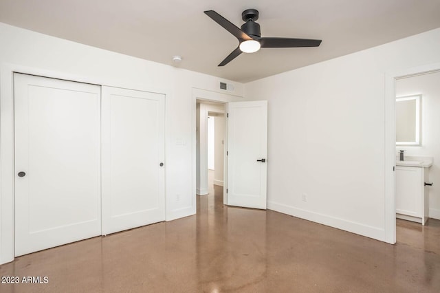 unfurnished bedroom with sink, ceiling fan, and a closet