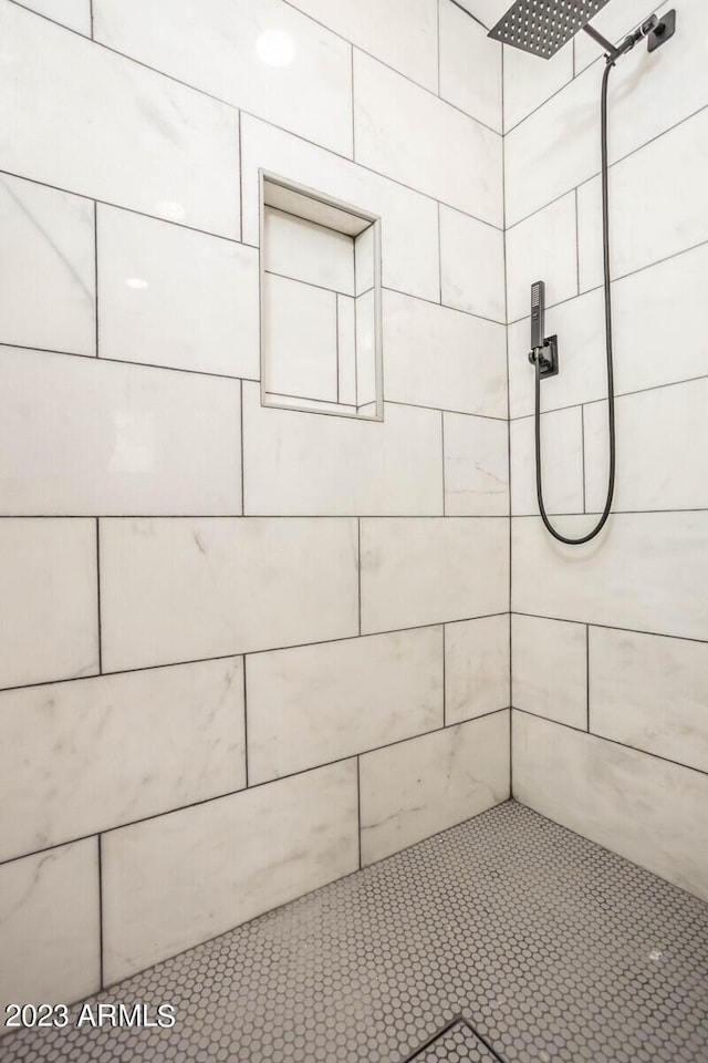 bathroom with tiled shower