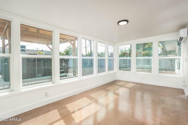 unfurnished sunroom with plenty of natural light and a wall mounted AC