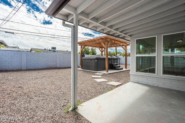 view of patio / terrace featuring a pergola and a hot tub