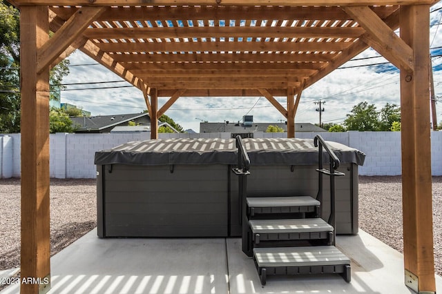 view of patio / terrace with a pergola and a hot tub