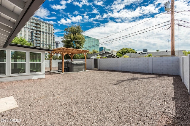 view of yard featuring a pergola and a hot tub