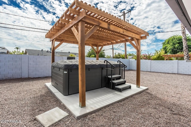 view of patio / terrace with a hot tub and a pergola