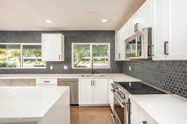 kitchen featuring white cabinetry, sink, a healthy amount of sunlight, and appliances with stainless steel finishes