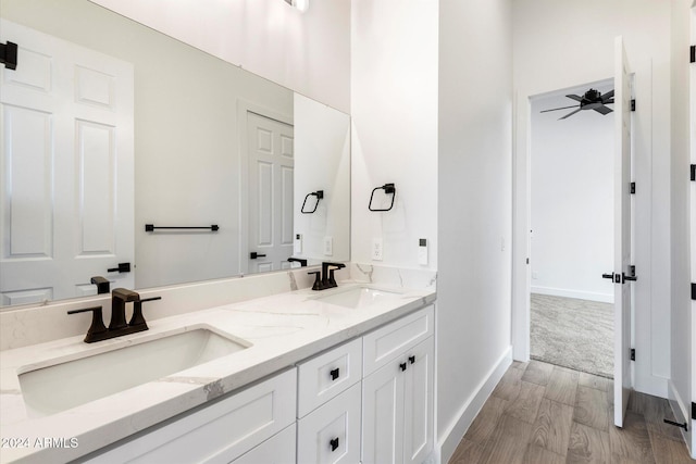 bathroom with hardwood / wood-style floors, vanity, and ceiling fan