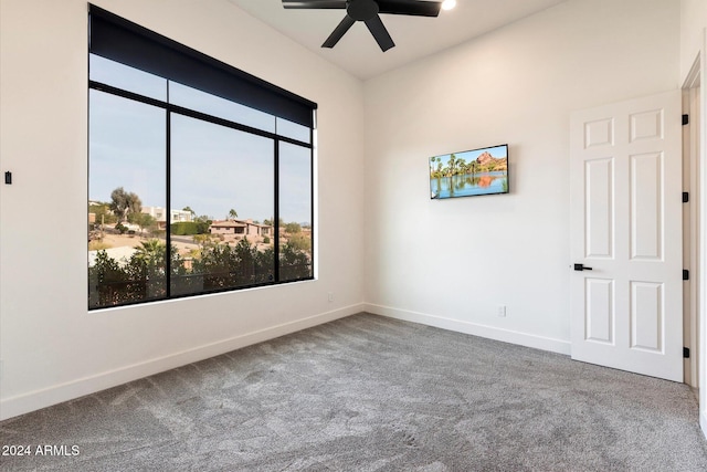 empty room with ceiling fan and carpet floors