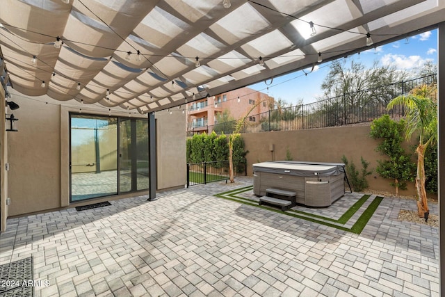 view of patio / terrace featuring a pergola and a hot tub