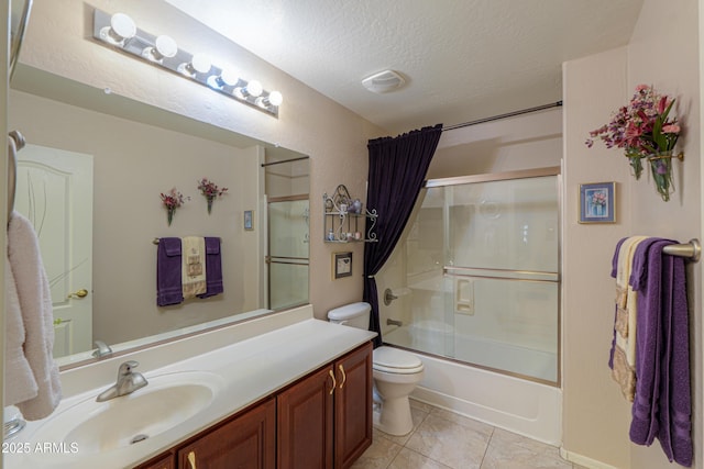 full bathroom with shower / bath combination with glass door, vanity, toilet, tile patterned floors, and a textured ceiling