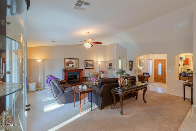 living room featuring light carpet, vaulted ceiling, and ceiling fan