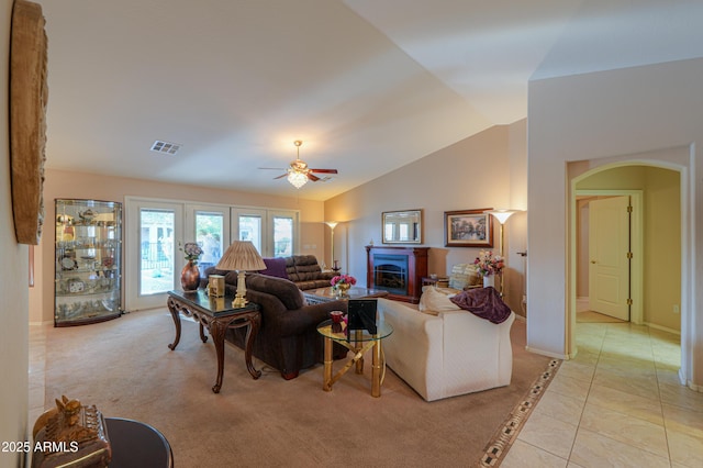 living room with vaulted ceiling, ceiling fan, and light tile patterned flooring