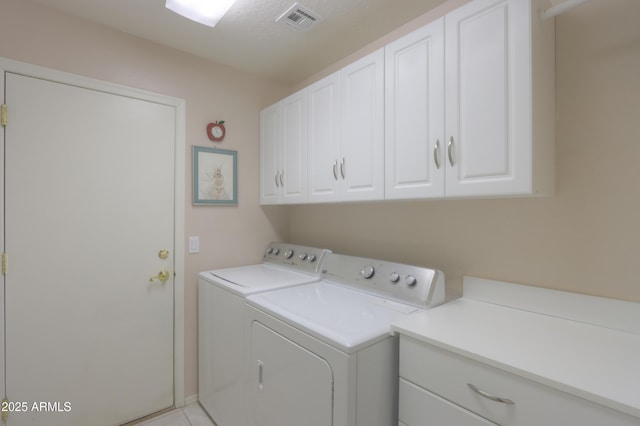 washroom with cabinets and separate washer and dryer