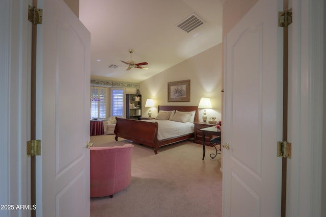 bedroom with vaulted ceiling, light colored carpet, and ceiling fan