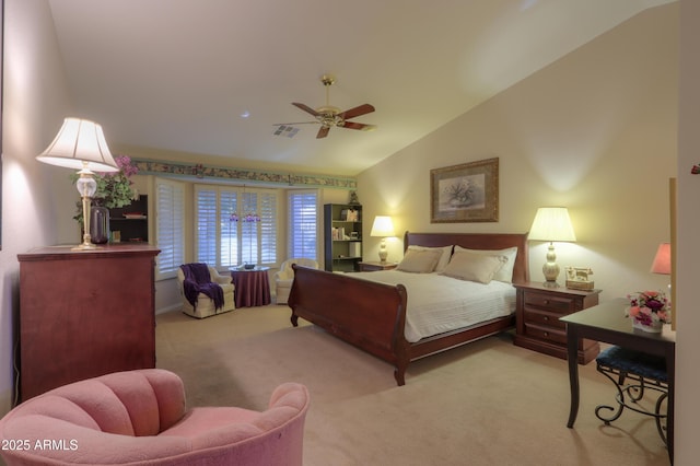 carpeted bedroom with ceiling fan and vaulted ceiling