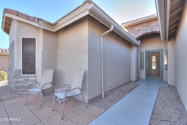 entrance to property featuring a patio