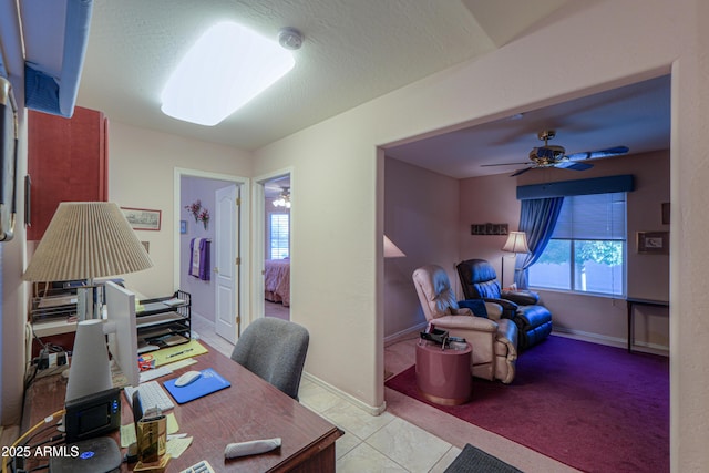 tiled office featuring ceiling fan, a healthy amount of sunlight, and a textured ceiling