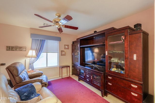 carpeted living room featuring ceiling fan