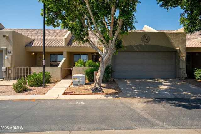 64 N 63rd St N Unit 33, Mesa, AZ 85205 - view of front of property with stucco siding, a tiled roof, an attached garage, driveway, and a gate