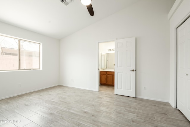 64 N 63rd St N Unit 33, Mesa, AZ 85205 - unfurnished bedroom featuring a closet, lofted ceiling, light wood-style flooring, ceiling fan, and connected bathroom
